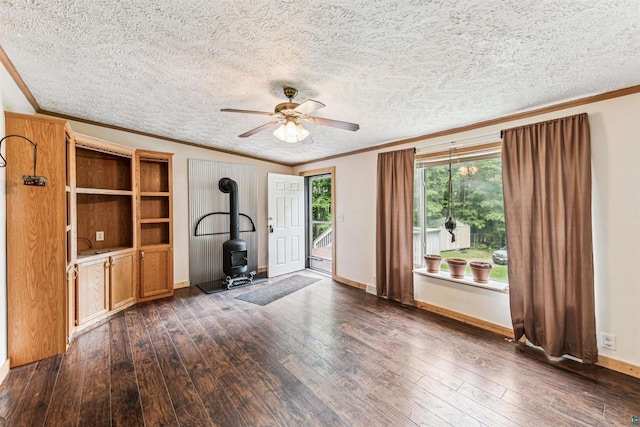 33315 State Highway 13, Bayfield, WI 54814 - unfurnished living room with a wood stove, ornamental molding, dark wood-style floors, ceiling fan, and a textured ceiling
