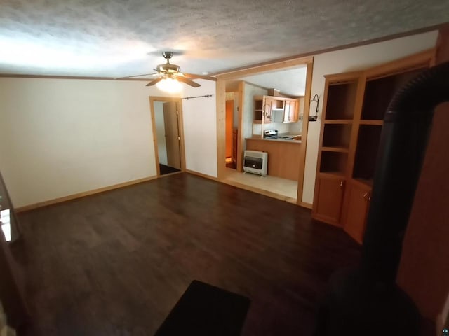 33315 State Highway 13, Bayfield, WI 54814 - unfurnished living room with heating unit, ceiling fan, dark wood-style floors, a textured ceiling, and ornamental molding