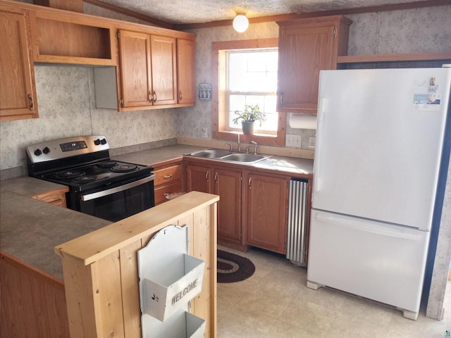 33315 State Highway 13, Bayfield, WI 54814 - kitchen with freestanding refrigerator, electric stove, radiator heating unit, and open shelves