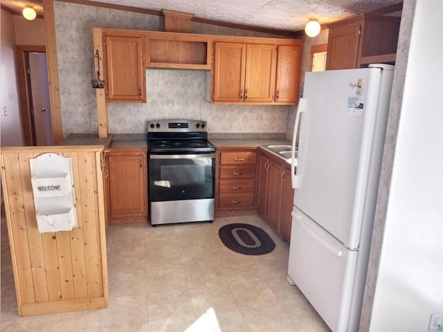 33315 State Highway 13, Bayfield, WI 54814 - kitchen with stainless steel range with electric cooktop, freestanding refrigerator, and brown cabinets