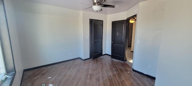 unfurnished bedroom featuring ceiling fan and dark hardwood / wood-style floors