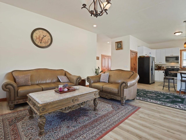 living room featuring light hardwood / wood-style floors and a notable chandelier