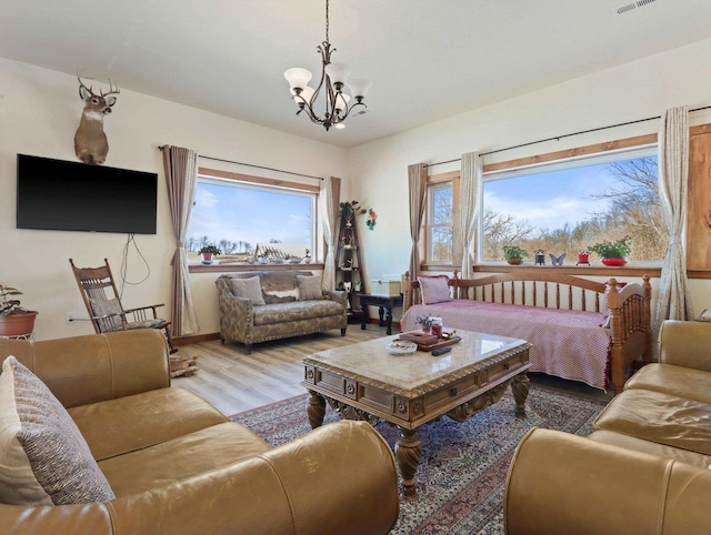 living room with an inviting chandelier and hardwood / wood-style floors