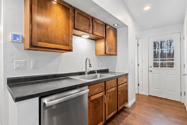 kitchen featuring a sink, dark countertops, brown cabinets, and dishwasher