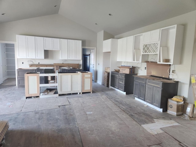 kitchen with gray cabinets, white cabinetry, and high vaulted ceiling