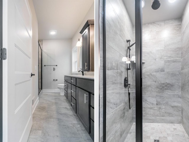 bathroom with vanity, toilet, and an enclosed shower