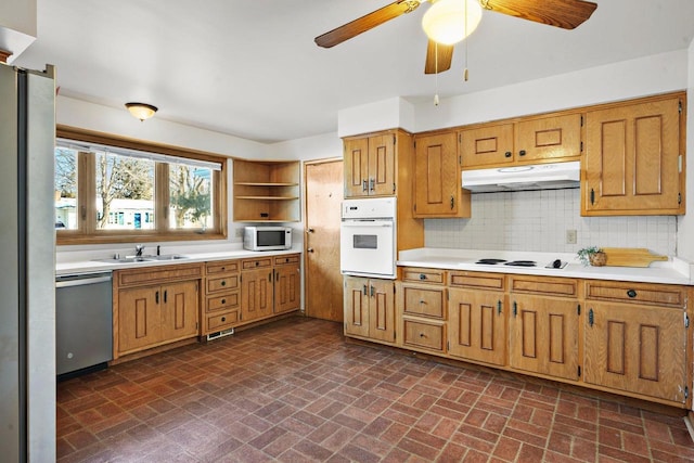 kitchen with ceiling fan, sink, tasteful backsplash, and stainless steel appliances