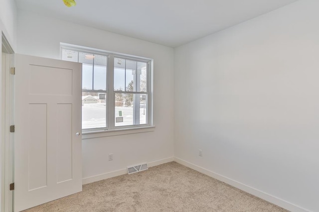 empty room with light colored carpet