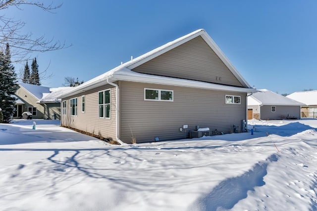 view of snow covered rear of property