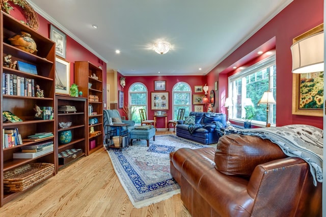 living area featuring crown molding and light wood-type flooring