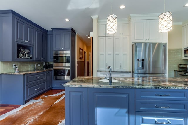 kitchen featuring dark stone countertops, hanging light fixtures, sink, and appliances with stainless steel finishes