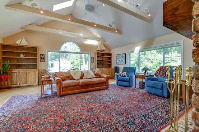 living room featuring lofted ceiling with skylight and light wood-type flooring