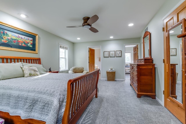 carpeted bedroom featuring ceiling fan and ensuite bathroom