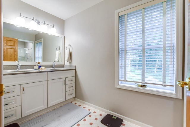 bathroom with vanity and a shower with door