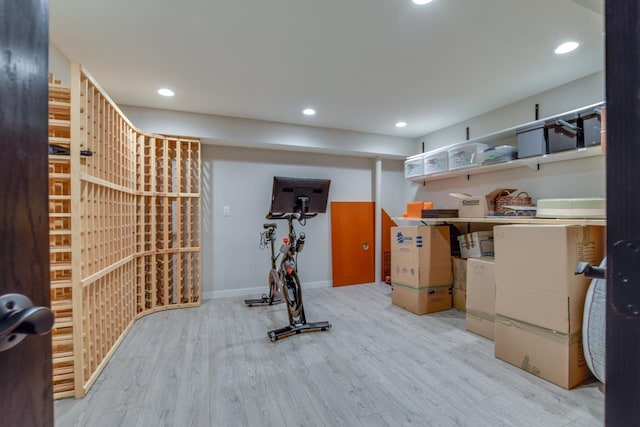 exercise room with light wood-type flooring