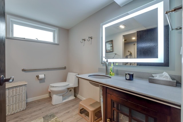 bathroom with wood-type flooring, toilet, and sink