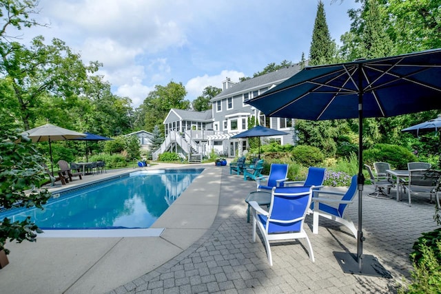 view of swimming pool featuring a patio area