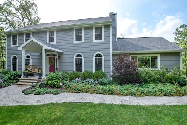 colonial-style house with a front lawn