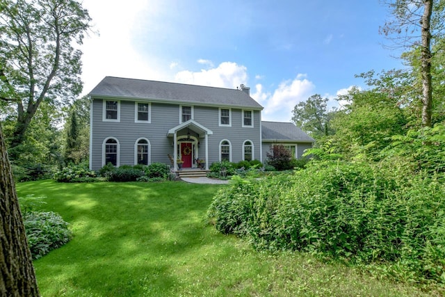 colonial-style house with a front lawn