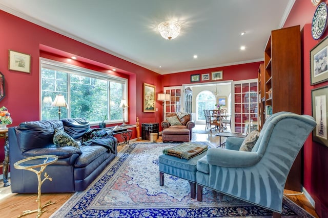 living room featuring ornamental molding and light hardwood / wood-style floors