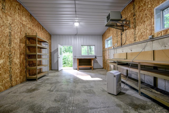 misc room with a healthy amount of sunlight and concrete floors