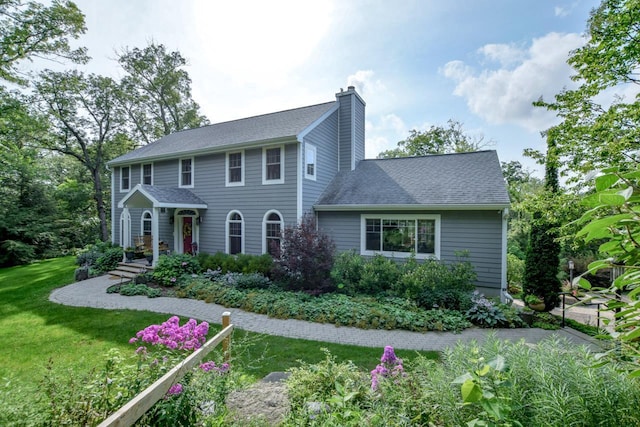 colonial inspired home with a front yard