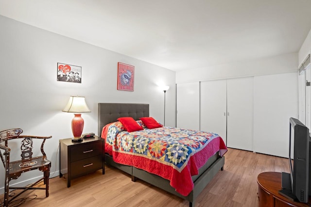 bedroom with light wood-style floors and a closet