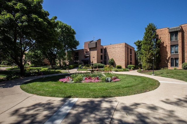 view of home's community featuring a lawn