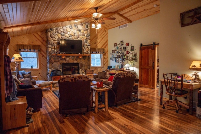 living room with hardwood / wood-style flooring, a barn door, and wooden ceiling