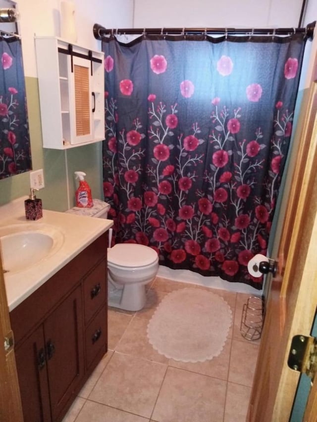 bathroom featuring tile patterned floors, toilet, vanity, and a shower with shower curtain