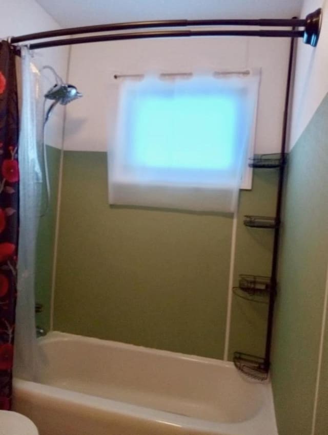 full bath with toilet and shower / bath combo