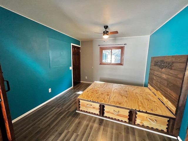 unfurnished bedroom with baseboards, ceiling fan, and dark wood-style flooring