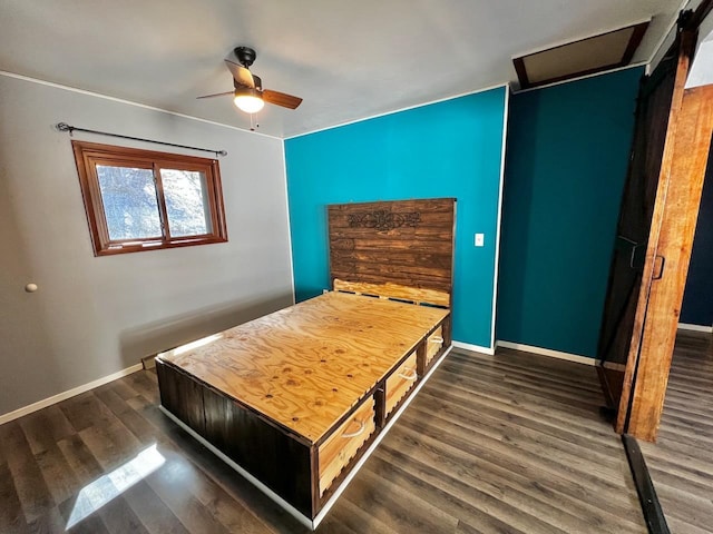 unfurnished bedroom with baseboards, ceiling fan, and dark wood-style flooring