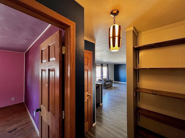 hallway with dark wood finished floors and baseboards