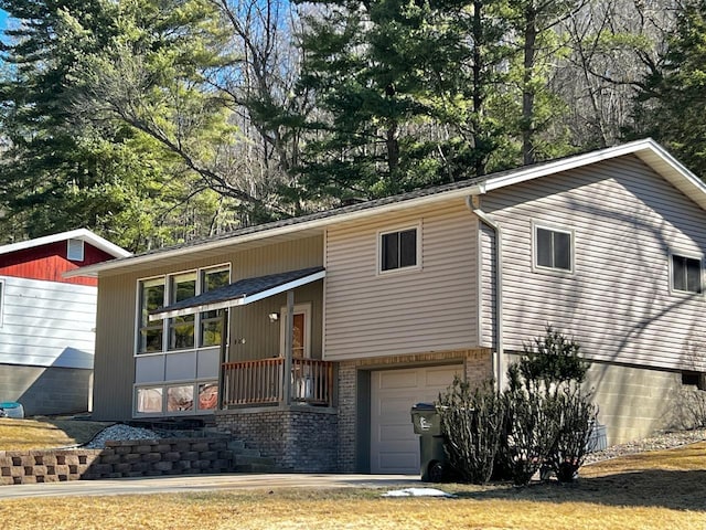 view of front facade with brick siding and an attached garage