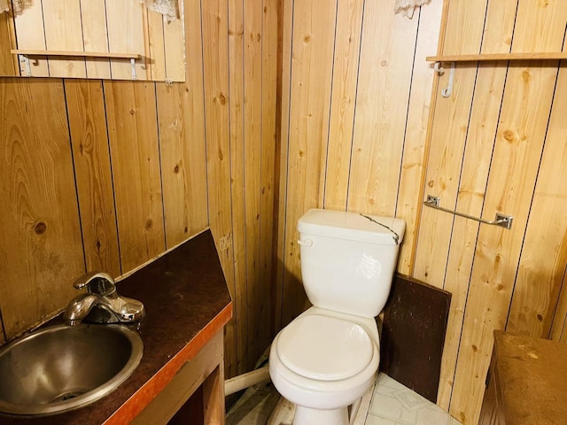 W7679 Oak St, Shiocton, WI 54170 - bathroom with toilet, vanity, and wood walls