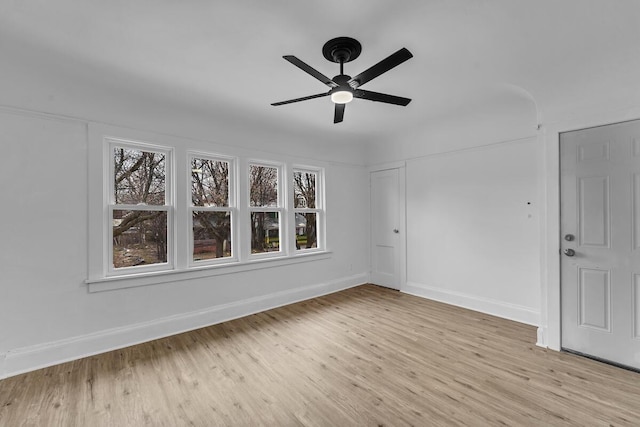 spare room featuring ceiling fan, a healthy amount of sunlight, and light hardwood / wood-style floors