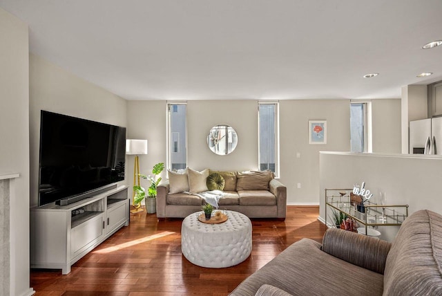 living room featuring dark wood-style flooring and baseboards