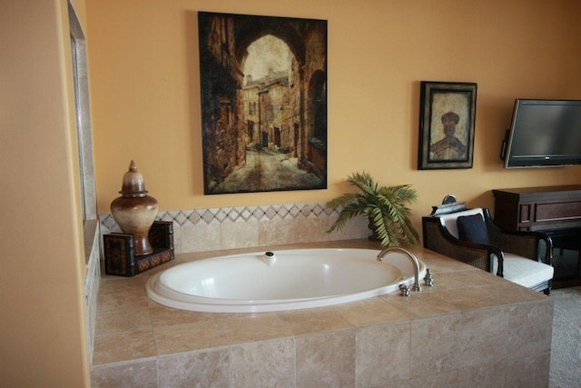 bathroom featuring tiled bath