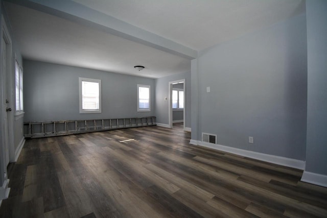 empty room with dark hardwood / wood-style flooring