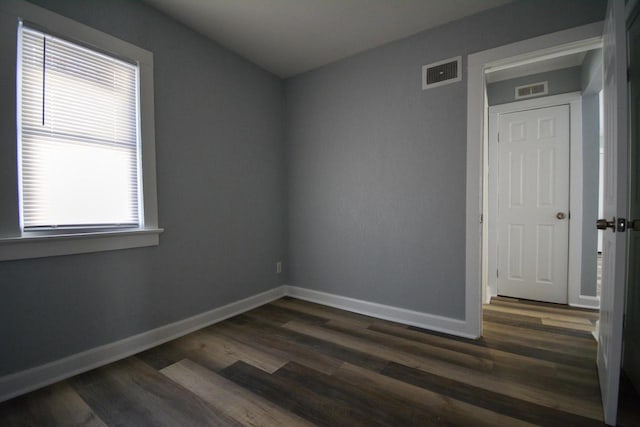 spare room with dark hardwood / wood-style flooring