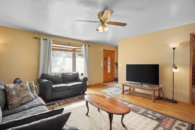 living room featuring light hardwood / wood-style floors and ceiling fan