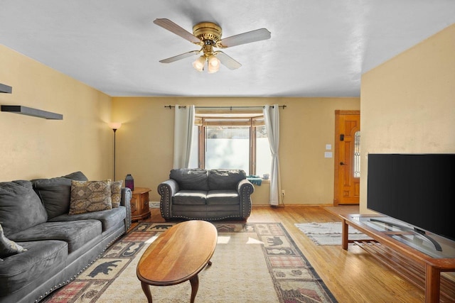 living room featuring ceiling fan and light hardwood / wood-style flooring