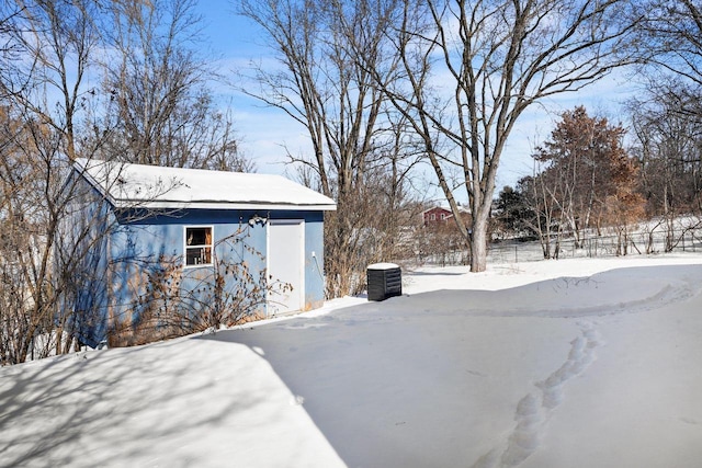 yard layered in snow featuring central air condition unit