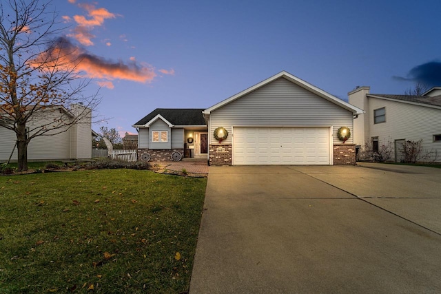 ranch-style house with a garage and a yard