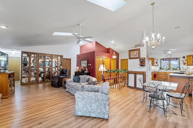 living room featuring ceiling fan, a skylight, and light wood-type flooring