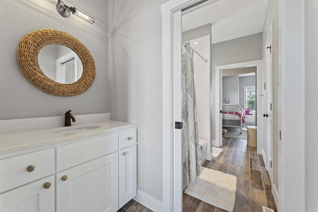 bathroom featuring vanity, hardwood / wood-style floors, and a shower with curtain