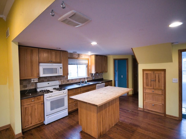 24713 68th St, Salem, WI 53168 - kitchen with sink, white appliances, dark hardwood / wood-style floors, and a kitchen island