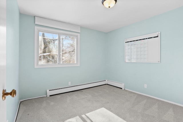 unfurnished room featuring a baseboard radiator and light carpet