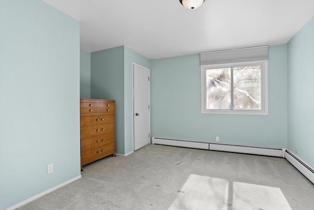 unfurnished bedroom featuring a baseboard radiator and light colored carpet